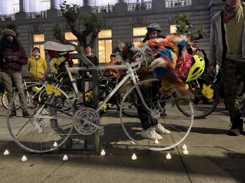 Attendees arrive at City Hall to place a ghost bike in front of it, for the last four years officials have lit up the building white to honor the ride on Wednesday May 15, 2024. Photo by Oscar Palma.