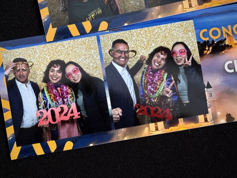 Three people pose for fun photos with 2024 glasses, colorful accessories, and silly expressions in a photo booth.