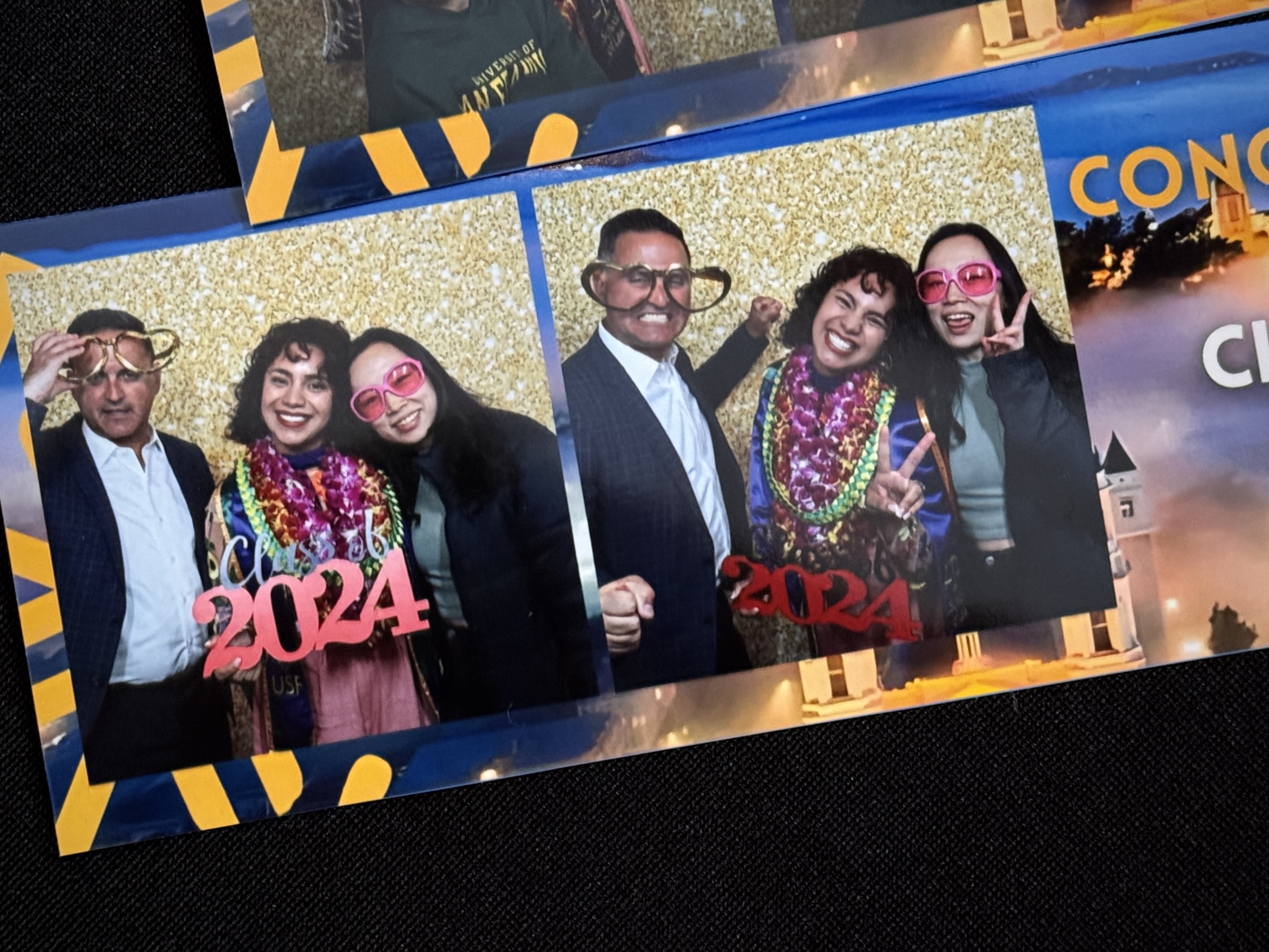 Three people pose for fun photos with 2024 glasses, colorful accessories, and silly expressions in a photo booth.
