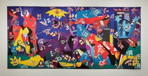 A colorful quilt, perfect for museum displays, featuring a collage of abstract shapes, numbers, and letters on a vibrant background.