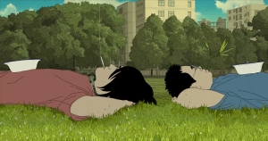 Two people lie on the grass in a park with white bowls on their chests, surrounded by trees and buildings in the background.