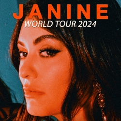 Close-up of a woman with long hair, bold makeup, and dangling earrings, with text above her head that reads "JANINE: WORLD TOUR 2024.