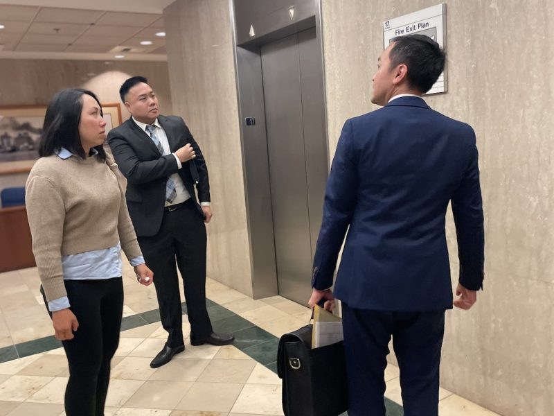 In the black suit is Cyril Yu, and in the blue suit is Yu’s attorney, Nghi Lam.