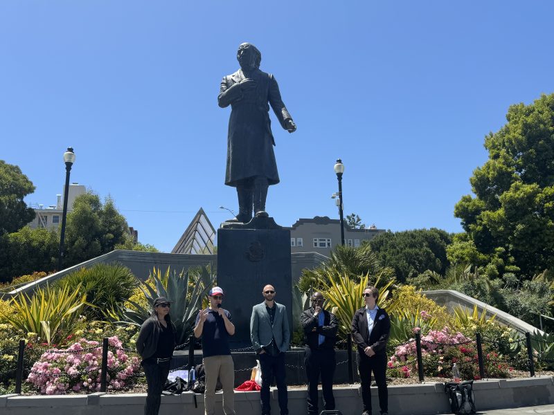From left to right, mayoral candidates Serena Hugnes, Dylan Hirsch-Shell, Shahram Shariati, Guy Mccoy and Honest Charley Bodkin behind the Miguel Hidalgo monument in Dolores Park during the first People's debate for mayor of the season on Saturday June 1, 2024. Photo by Oscar Palma.