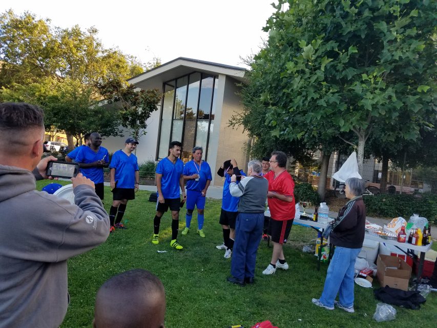 Jackie Lafferty hands medals to the winning team after one of the group's own soccer tournaments in July 2019. Photo courtesy of Raul Fernandez.