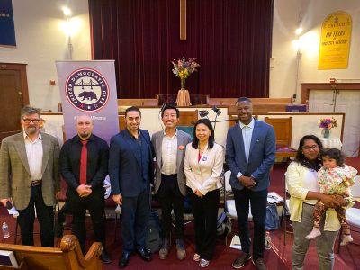 Patrick Hoge, San Francisco Examiner reporter and moderator of the forum, Jose Morales, Roger Marenco, Michael Lai, Chyanne Chen, Ernest "E.J." Jones, and Adlah Chisti holding her daughter. District 11 forum