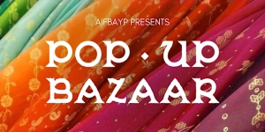 Colorful fabric background with text overlay reading "AllFabyP Presents Pop-Up Bazaar".