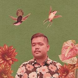 A person with a mustache wearing a floral shirt stands in front of a green background, surrounded by flowers and two birds flying.