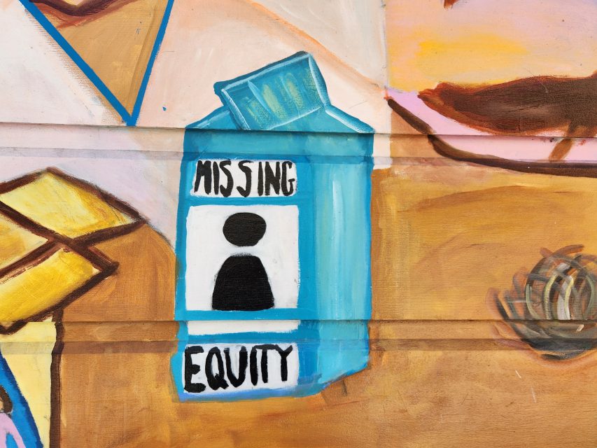 A mural depicting a blue milk carton with the words "Missing Equity" and a blank silhouette in place of a missing person's photo.