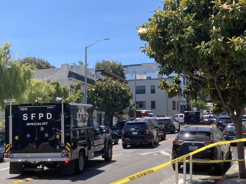 SWAT vehicles on the streets behind yellow caution tape 