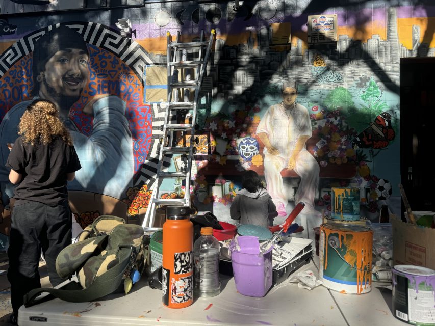 Friends and family paint a mural for Luis Arguello-Inglis at the intersection of 24th and Folsom streets on Tuesday May 16, 2024. Photo by Oscar Palma