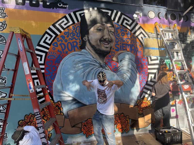 Friends and family paint a mural for Luis Arguello-Inglis at the intersection of 24th and Folsom streets on Tuesday May 16, 2024. Photo by Oscar Palma
