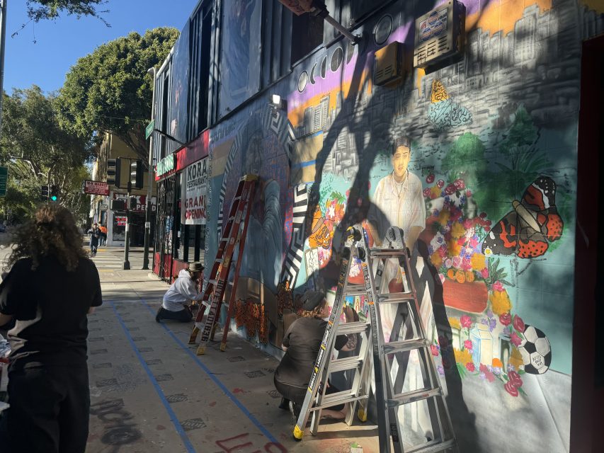 Friends and family paint a mural for Luis Arguello-Inglis at the intersection of 24th and Folsom streets on Tuesday May 16, 2024. Photo by Oscar Palma