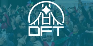 A crowd of people gathered at an outdoor event, with the acronym "DFT" prominently displayed over the image.
