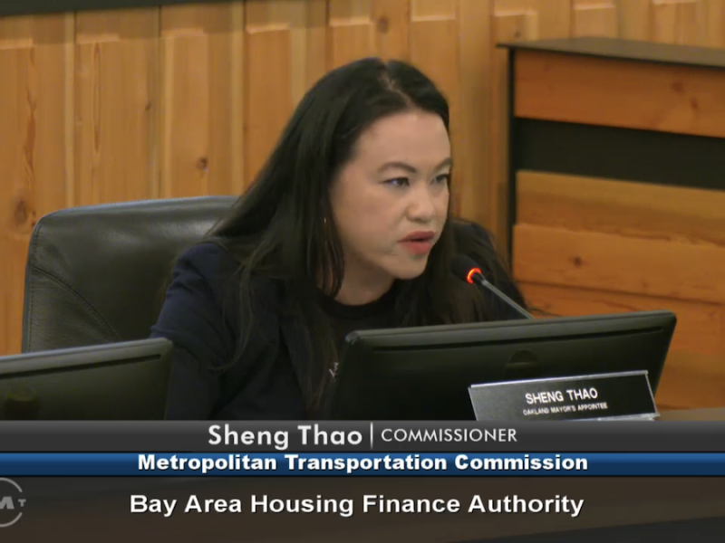 Sheng Thao, a commissioner at the Metropolitan Transportation Commission, is speaking into a microphone during a Bay Area Housing Finance Authority meeting.