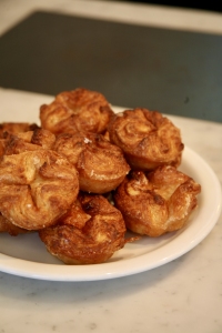 Plate of brown, crispy pastries on a marble countertop.