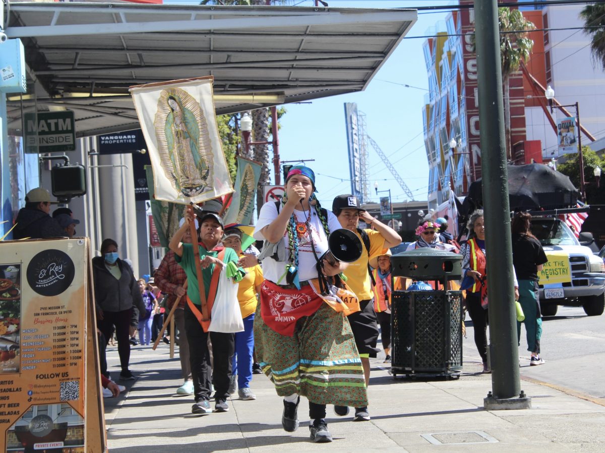 Volunteers march through Mission Street on their way to City Hall.