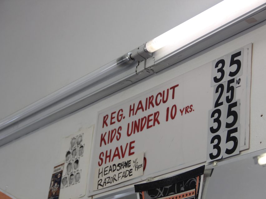 A price board inside of Abner's Barbershop on Thursday Aug. 22, 2024. Photo by Oscar Palma.