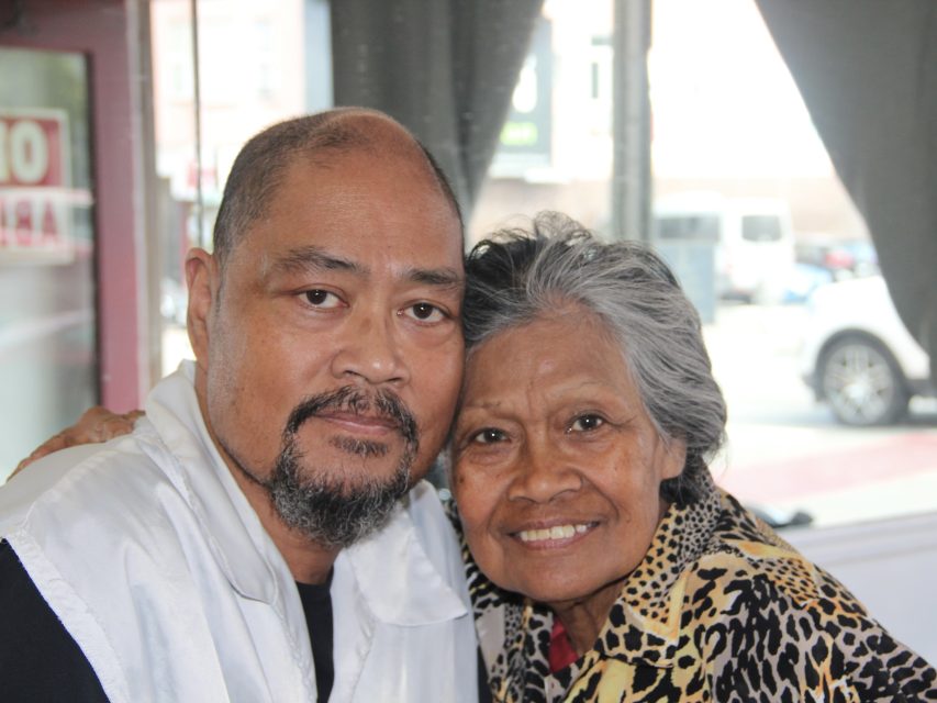 Maria and Abner Bollozos pose for a photo inside of Abner's Barbershop, the business Maria started in 1986, on Thursday Aug. 22, 2024. Photo by Oscar Palma.