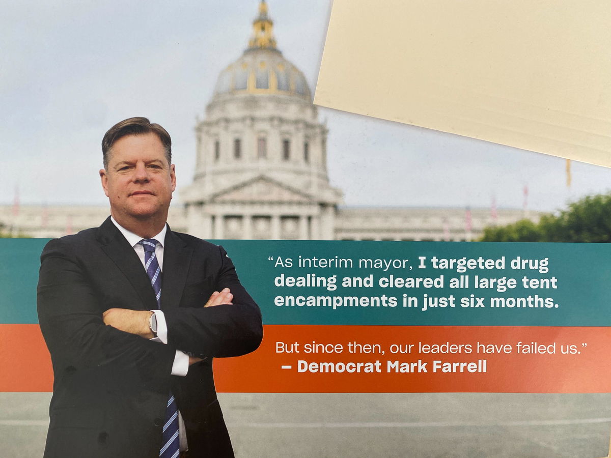 A man in a suit stands with arms crossed in front of a domed building. The text reads: "As interim mayor, I targeted drug dealing and cleared all large tent encampments in just six months. –Democrat Mark Farrell.