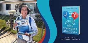 A person holding newspapers stands outside a house with a dog visible in the background. A book cover titled "The Joy of Talking Politics with Strangers" is displayed on the right side.