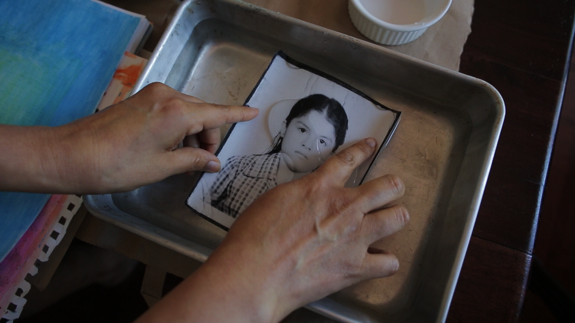 In a still from 'Prodigal Daughter,' Mabel Valdiviezo develops a photograph of herself as a young girl.