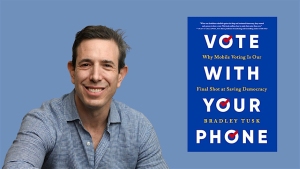 A man in a blue shirt smiles beside a book titled "Vote With Your Phone" by Bradley Tusk.