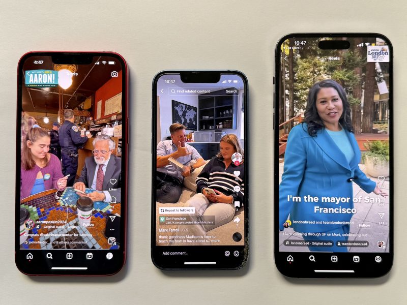 Three smartphones display videos: one shows two people at a café, the second features a couple on a couch, and the third depicts a woman speaking, with a caption about being the mayor of San Francisco.