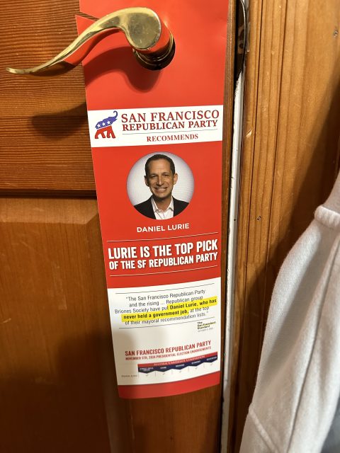 A door hanger promoting Daniel Lurie stands out as the top pick of the San Francisco Republican Party in the upcoming SF election, featuring a compelling photo and text endorsement.