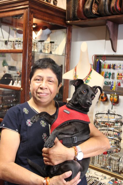 Diana Medina poses for a photo with her dog Yuma inside of her store on Thursday Nov. 7, 2024. Photo by Oscar Palma.
