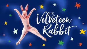 Person in a rabbit costume jumps against a blue background with colorful stars. Text reads "The Velveteen Rabbit.