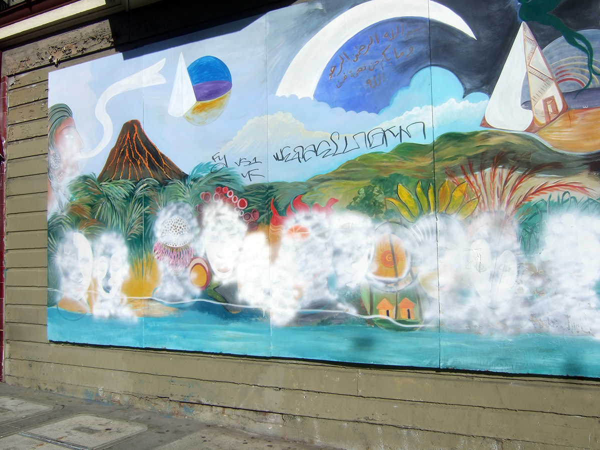 Colorful mural with mountains, planets, and abstract patterns on a wall, partially covered by white paint.