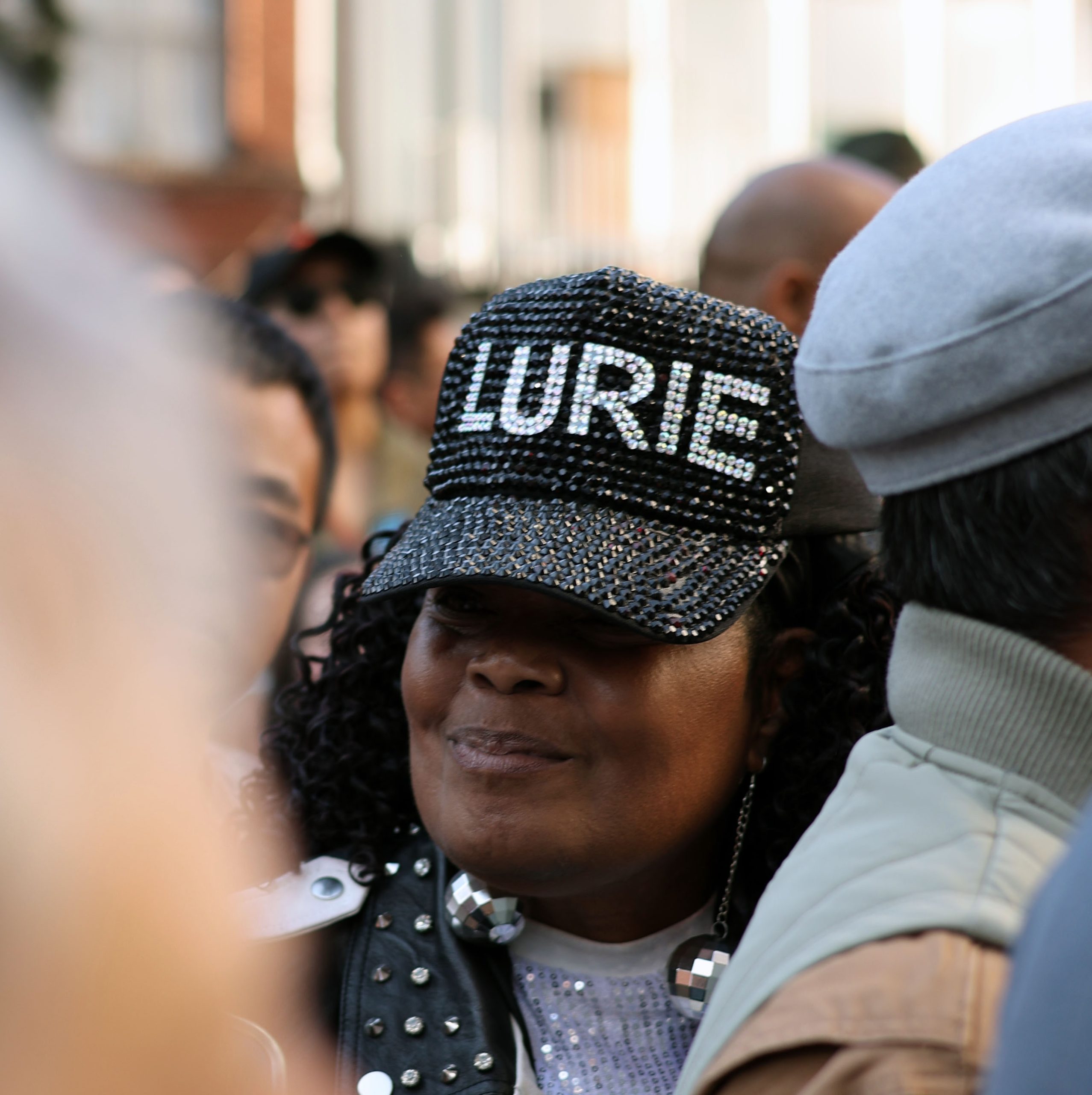A woman in a sparkly baseball hat that says "LURIE."