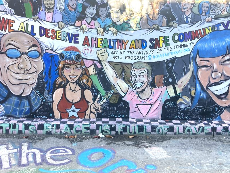 A mural of people holding a banner.