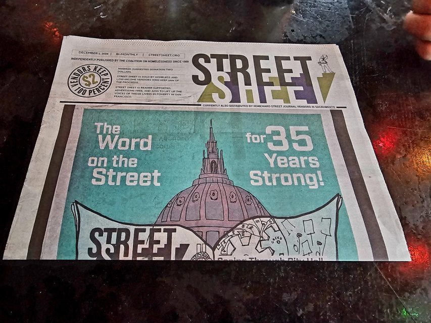 A newspaper titled "Street Sheet" on a table, featuring a headline celebrating 35 years.