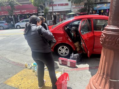 A woman selling goods out of her car at 24th and Mission Street on Thursday June 27th, 2024. Photo by Lydia Chavez.
