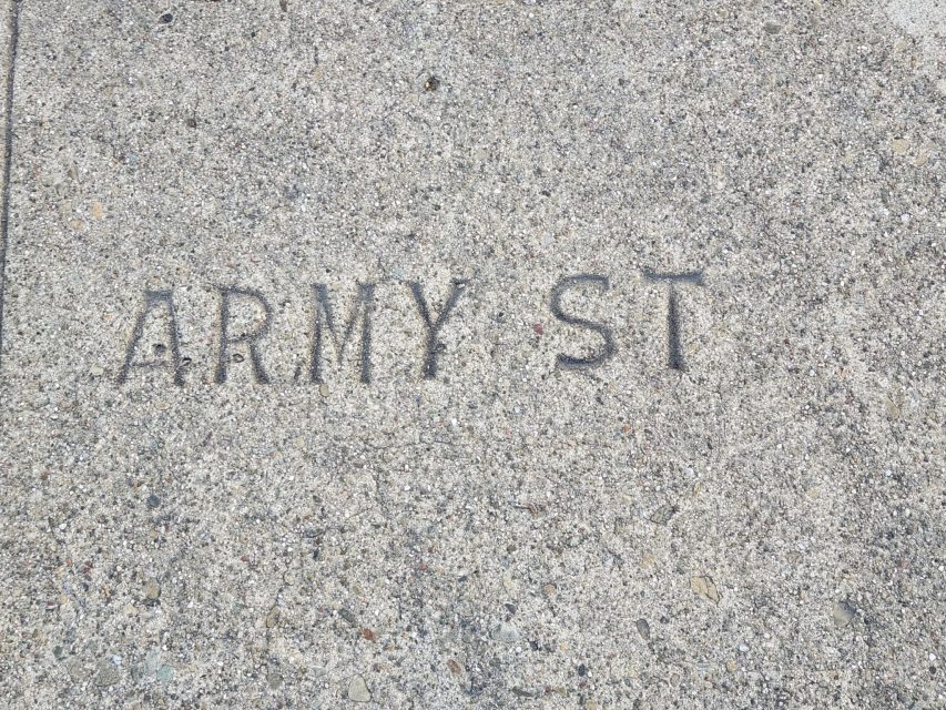 Concrete sidewalk with "ARMY ST" embossed in the surface.