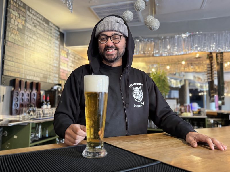 Danny Mendez, co-owner of Rosamunde, poses for a photo with his favorite beer, a Hafbrau lager, on Thursday Jan. 30, 2025. Photo by Oscar Palma.