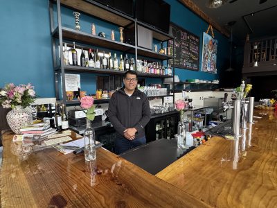 Hector Cortes poses behind the bar at Murales at 18th and Mission streets on Wednesday Jan. 29, 2024. Photo by Oscar Palma.