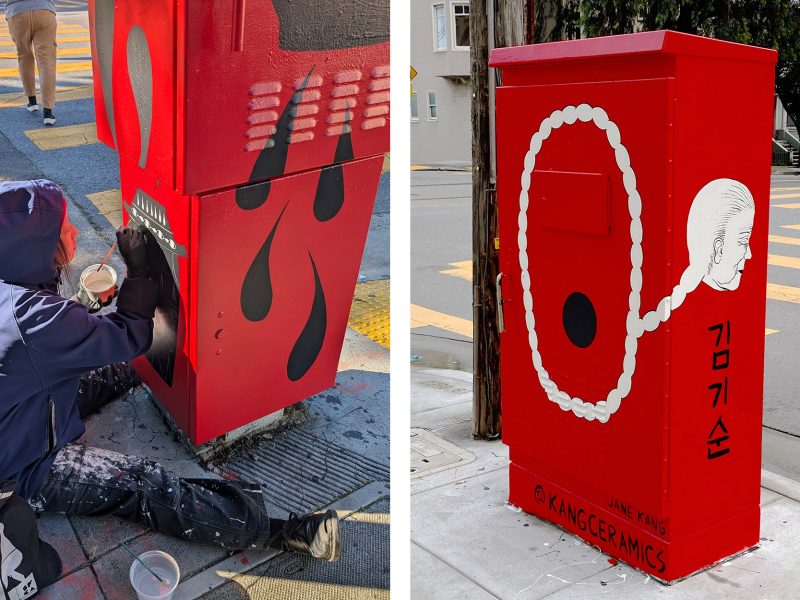Artist painting a red utility box with black flames and white smoke; completed design features bubbles and Korean text.