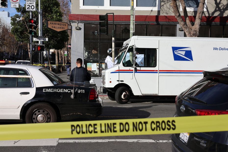 A USPS mail carrier's truck and a police car are stopped at an intersection, with police tape in the foreground reading "POLICE LINE DO NOT CROSS," casting a somber atmosphere over the scene.