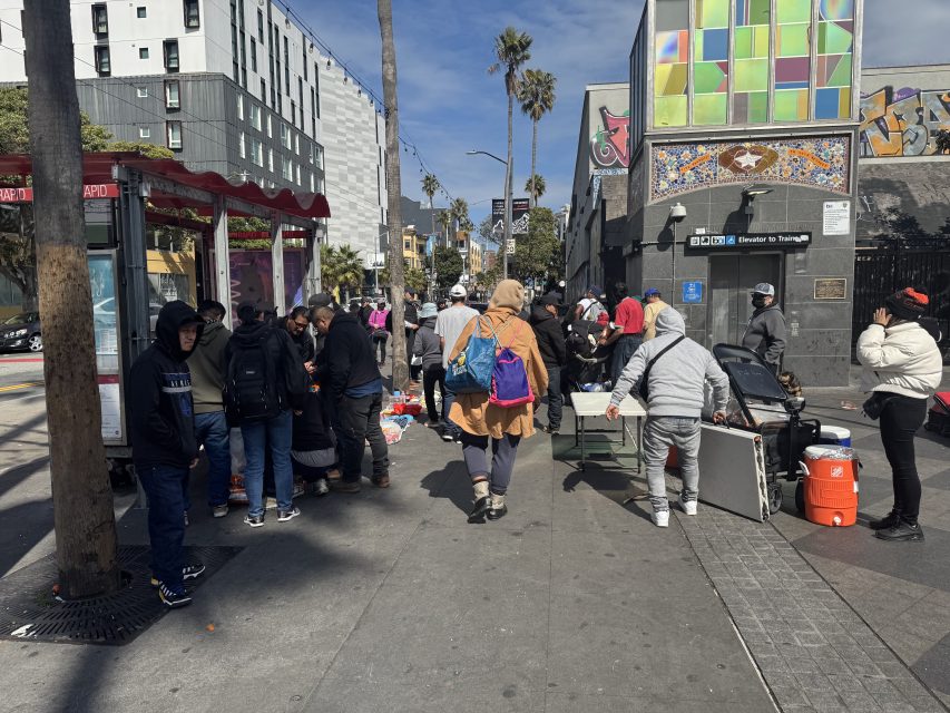 People set up shop next to the Northeastern 16th Street BART station on Tuesday March 11, 2025. Photo by Oscar Palma.
