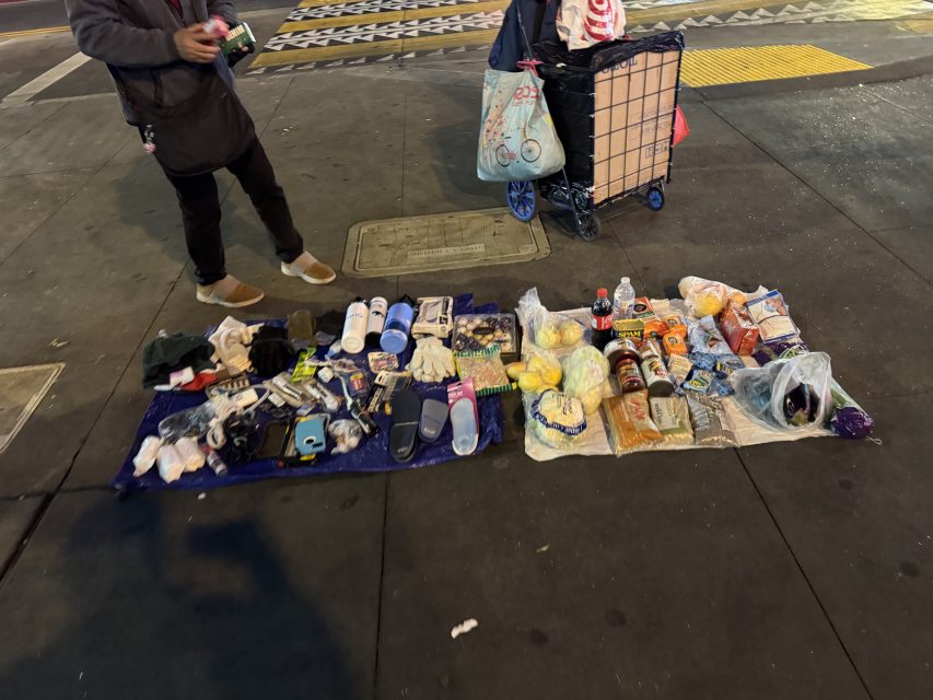 A woman sells groceries and cigarettes at the Southwestern 16th Street BART plaza on Monday March 1o, 2025. Photo by Oscar Palma.