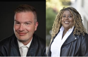 Two people in leather jackets. The person on the left has short hair and is smiling at the camera. The person on the right has curly hair and is smiling, looking slightly away from the camera.