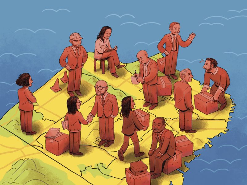 A group of diverse people in business attire interact on a map-like surface, discussing, writing, and shaking hands, with boxes and a chair around them.