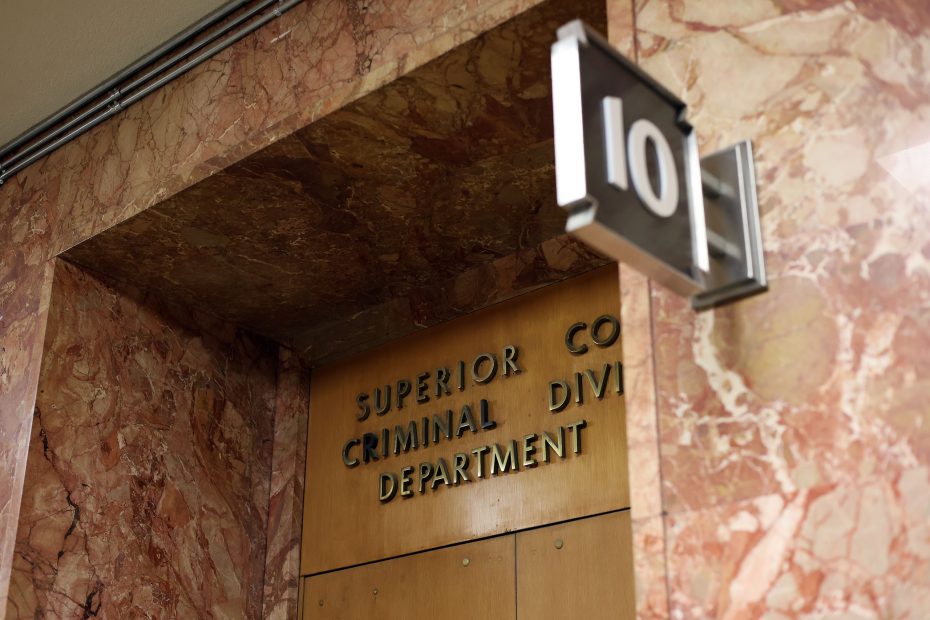 Sign for Room 101 at a Superior Court Criminal Division Department, with a marble-patterned wall background.