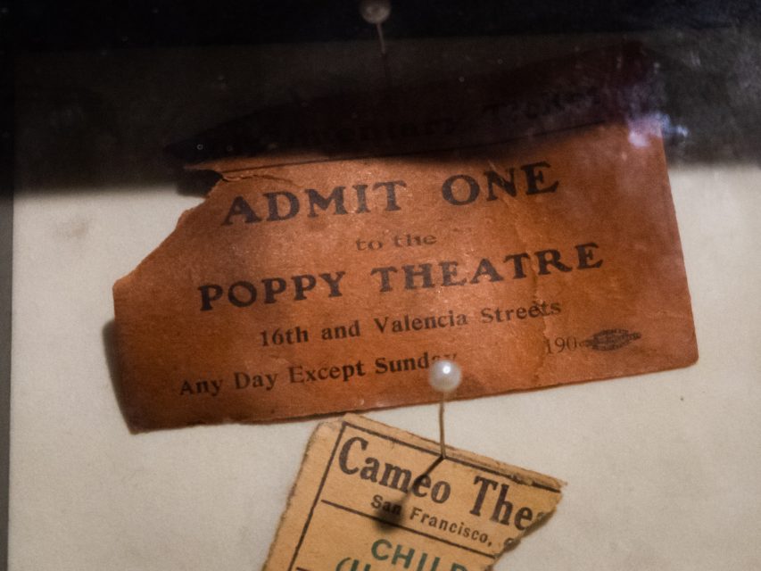A torn vintage ticket labeled "Admit One to the Poppy Theatre, 16th and Valencia Streets, Any Day Except Sunday, 190.