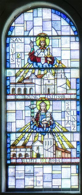 Stained glass window depicting religious figures, mission buildings, and dates "June 13, 1798" and "Sept. 17, 1804" with the text "San Luis Rey" and "Santa Inéz.