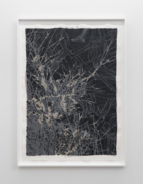 A framed artwork reminiscent of a museum piece, featuring intricate gray and silver branches over a dark background, with faint patterns and a shoe partially visible at the top.