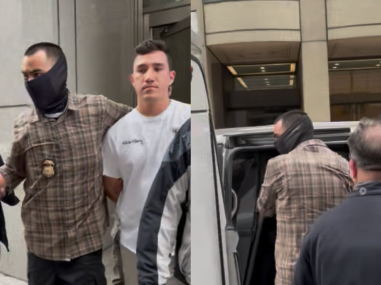 A man in a white t-shirt is being escorted by a masked officer and other individuals; the same officer is shown leading him into a vehicle.